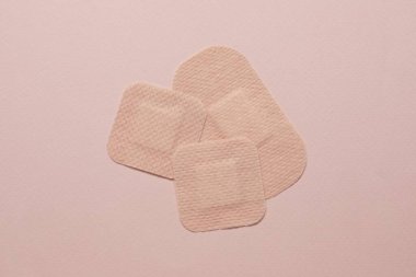 Contraceptive patches on pink background, flat lay