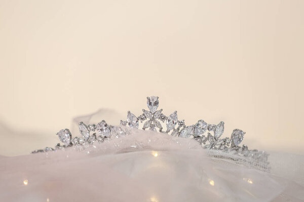 Beautiful silver tiara with diamonds on light cloth