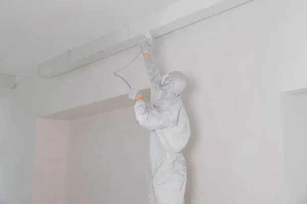 Decorator Protective Overalls Painting Ceiling Spray Gun Indoors — Fotografia de Stock