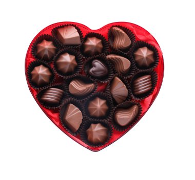 Heart shaped box with delicious chocolate candies on white background, top view
