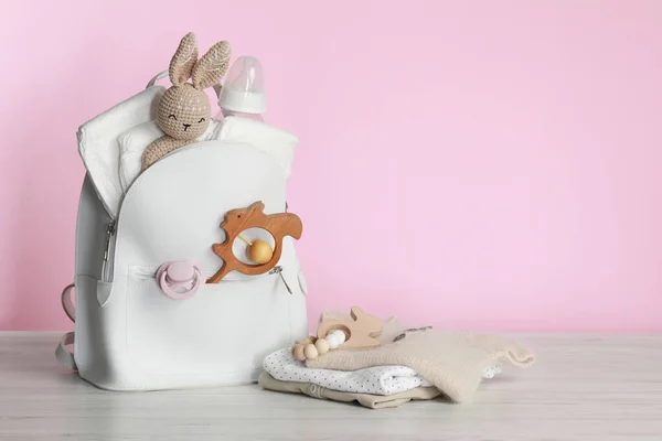 Mother Backpack Baby Stuff White Wooden Table Pink Background Space — 스톡 사진
