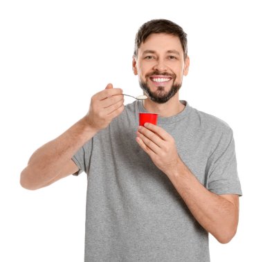 Handsome man with tasty yogurt on white background