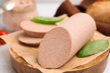 Delicious liver sausage on light grey table, closeup
