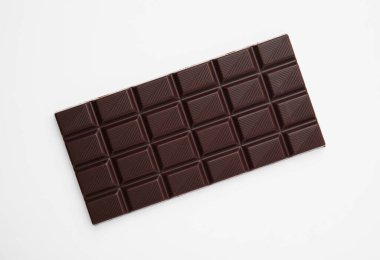Tasty chocolate bar on white background, top view