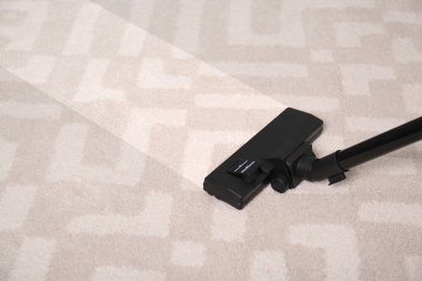 Vacuuming dirty carpet. Clean area after using device, closeup