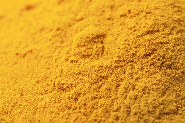 Aromatic turmeric powder on table, closeup view