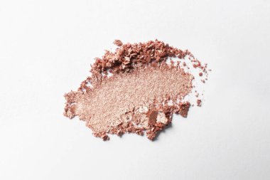 Crushed eye shadow on white background, top view. Professional makeup product