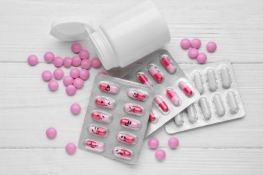 Antidepressants and medical jar on white wooden table, flat lay