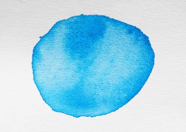 Blot of light blue watercolor paint on white background, top view