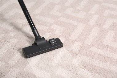 Vacuuming dirty carpet. Clean area after using device, closeup