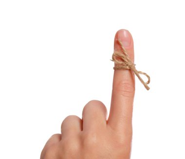 Woman showing index finger with tied bow as reminder on white background, closeup clipart