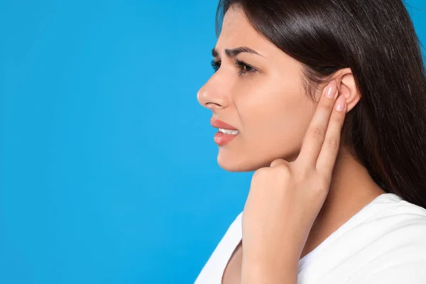 Young Woman Suffering Ear Pain Light Blue Background Closeup Space — Photo