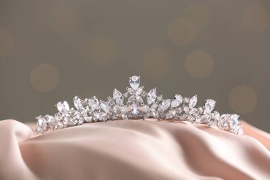 Beautiful silver tiara with diamonds on light cloth