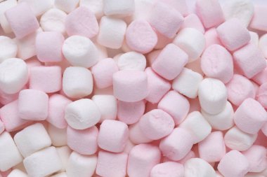 Delicious puffy pink and white marshmallows as background, top view