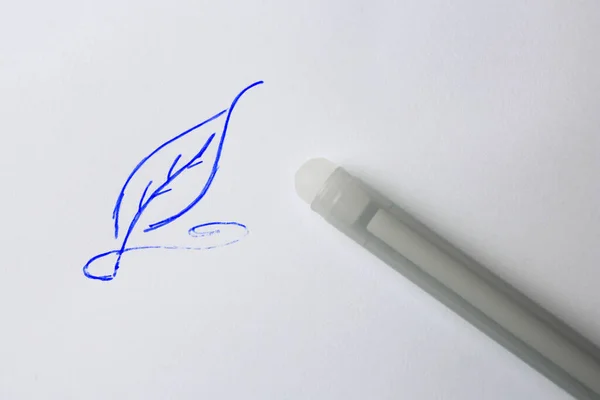 Leaf drawn on sheet of paper with erasable pen, top view
