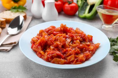 Delicious lecho on light gray table, closeup