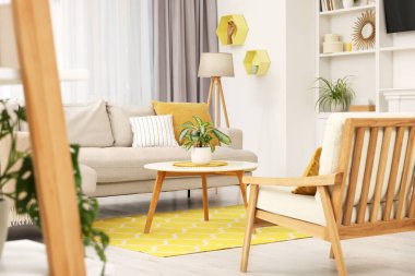 Spring atmosphere. Stylish room interior with cozy furniture in yellow and white colors