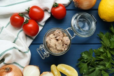 Flat lay composition with tasty cod liver and different products on blue wooden table