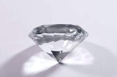 Beautiful dazzling diamond on pink background, closeup