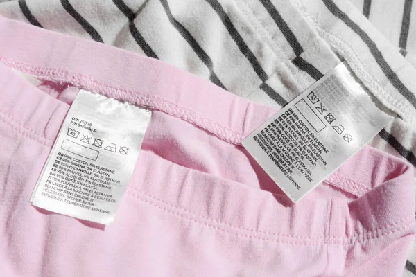 Clothing labels with instructions on garments, top view