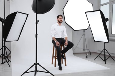 Handsome model posing in modern studio. Professional photo session