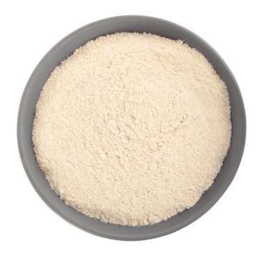 Ceramic bowl with quinoa flour on white background, top view