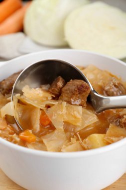 Tasty cabbage soup with meat and carrot, closeup