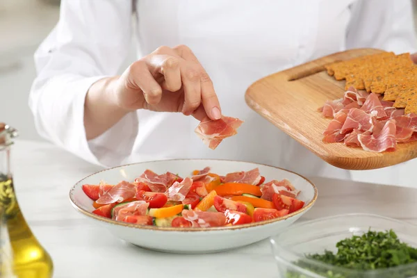 Professional Chef Adding Prosciutto Delicious Dish White Marble Table Closeup — Stockfoto