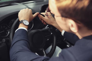 Man checking time in car, closeup. Being late