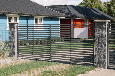 Metal gates near beautiful buildings on sunny day