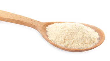 Wooden spoon with quinoa flour on white background, closeup