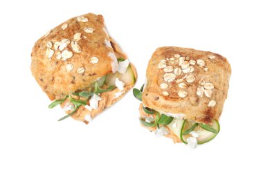 Delicious sandwiches with hummus, microgreens and cucumber slices isolated on white, top view
