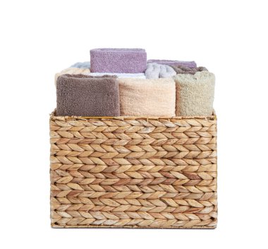 Wicker laundry basket with clean terry towels isolated on white