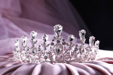 Beautiful silver tiara with diamonds on light cloth