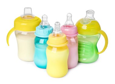 Feeding bottles with milk on white background