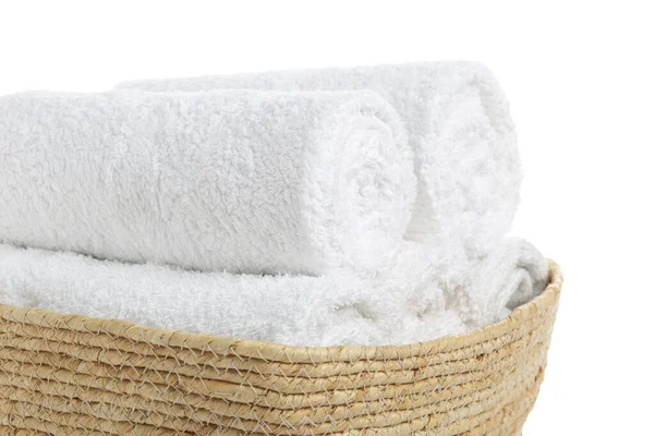 Wicker laundry basket with clean towels isolated on white