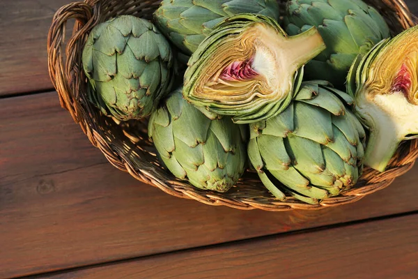 Wicker Basket Fresh Raw Artichokes Wooden Table Top View — Stock Photo, Image