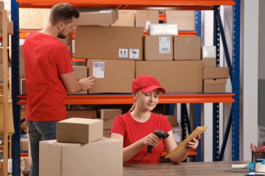 Man and woman working at post office