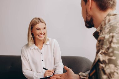 Psychologist working with military officer in office
