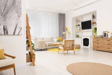 Spring atmosphere. Stylish room interior with cozy furniture in yellow and white colors
