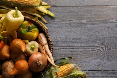 Different fresh ripe vegetables and fruits on grey wooden table, flat lay. Space for text