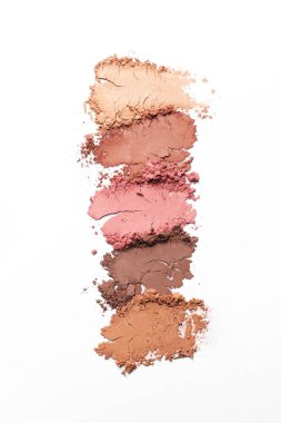 Crushed eye shadows on white background, top view. Professional makeup product
