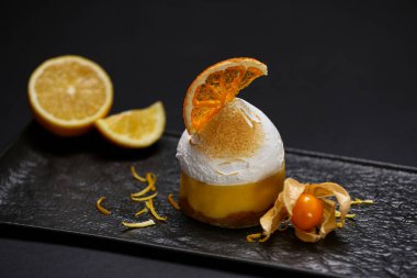 Beautiful composition of delicious dessert on black background, closeup. Food stylist