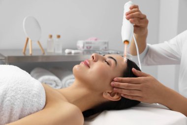 Darsonval 'la birlikte güzellik salonunda gençleştirme işlemi geçiren genç bir kadın.