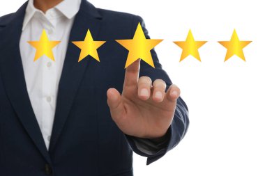 Quality evaluation. Businessman touching virtual golden star on white background, closeup