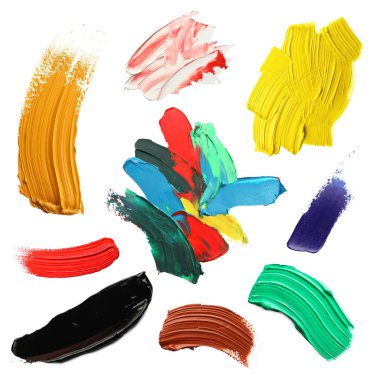 Set with strokes of colorful oil paints on white background, top view