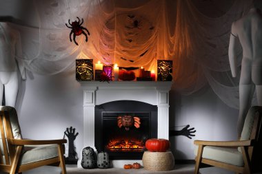 Room with fireplace decorated for Halloween. Festive interior