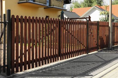 Closed wooden gates near beautiful houses outdoors