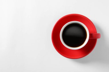 Cup with aromatic coffee on white background, top view. Space for text