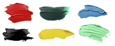 Set with strokes of colorful oil paints on white background, top view